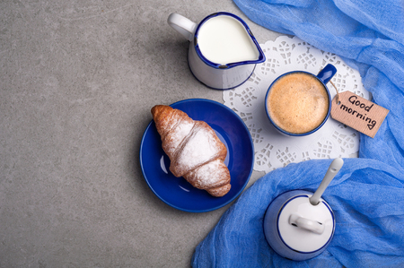 Breakfast with coffee cup, croissant and note good morning. Top view. Copy spaceの写真素材