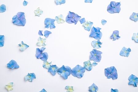 Flowers composition. Frame made of blue flowers hydrangea on white background. Creative floral texture. Flowers pattern, flat lay. Top view, copy spaceの写真素材