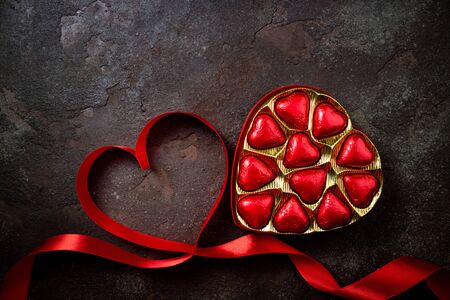 Valentines Day background with red heart and chocolate hearts. Heart shape from ribbons. Happy Valentine Dayの写真素材