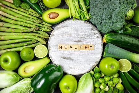 Healthy food clean eating green vegetables and fruits on dark stone background. Healthy food,...