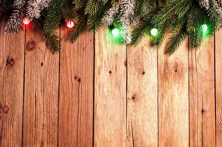 Christmas fir tree with colorful lights on dark wooden background. Christmas background with copy space.Top viewの写真素材