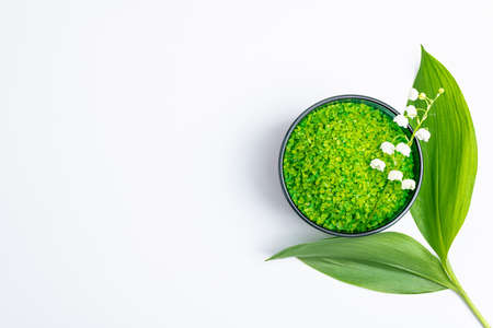 Spa treatment wellness concept. Natural spa cosmetics product herbal sea salt for bath with flowers on white background. Spa background flat lay. Copy space, top viewの写真素材