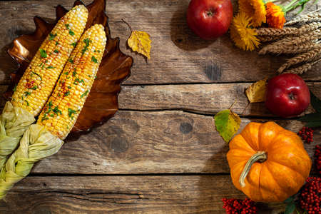 Autumn background for Thanksgiving. Autumn table setting for Thanksgiving dinner. Plate with corn,...