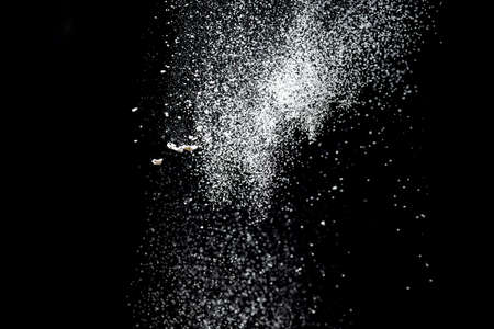 White powder explosion. White powder splash isolated on black background. Flour sifting on a dark background. Explosive powder whiteの写真素材