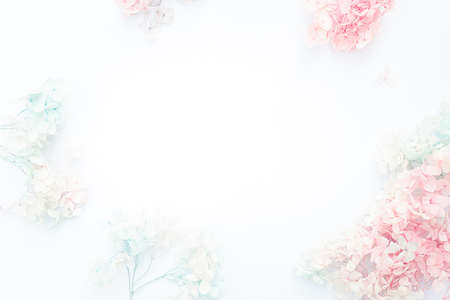 Flowers composition. Pattern made of pastel blue and pink flowers on white background. Flat lay, top view, copy spaceの写真素材
