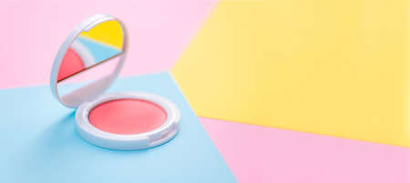 Makeup products pink blush decorative cosmetics on pastel color background flat lay. Fashion and...