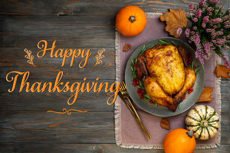 Thanksgiving Greetings. Roasted chicken or turkey for festive dinner on wooden table. Thanksgiving day conceptの写真素材