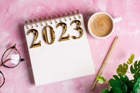 New year resolutions 2023 on desk. 2023 resolutions list with notebook, coffee cup on table. Goals, resolutions, plan, action, checklist concept. New Year 2023 template, copy spaceの写真素材