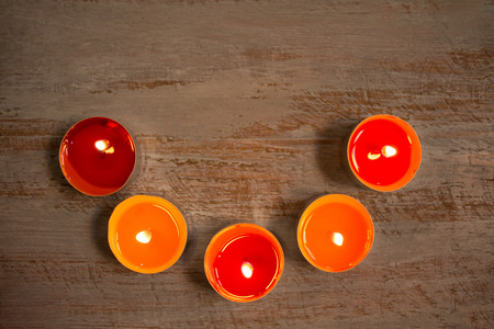 Beautiful colorful candles on the painted wooden boards.の写真素材