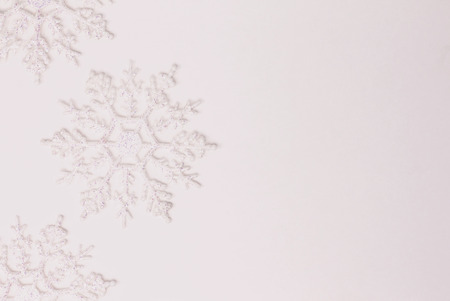 Three shiny white snowflakes on pure white background. Copy paste.の写真素材