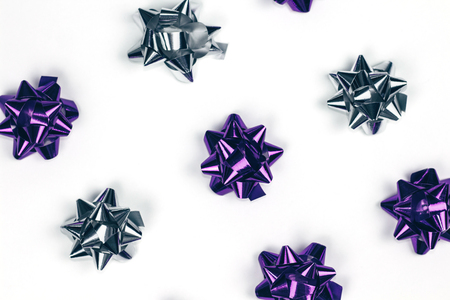 Christmas ornament of several violet and silver shiny decorations on white background.の写真素材