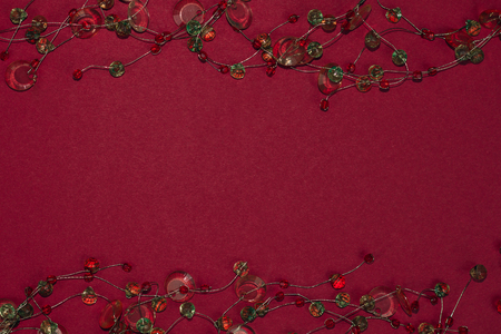 Beautiful colorful strass garland decoration on dark red background.の写真素材