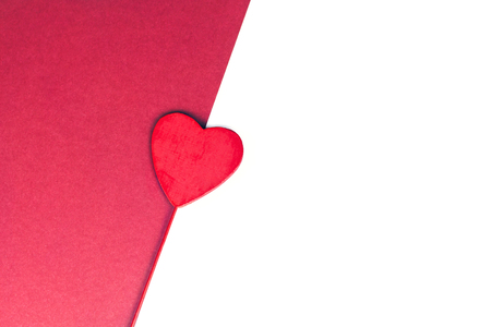Festive red heart concept for wedding or Valentines day on red and isolated white background. Copy space.の写真素材