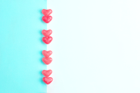 Concept made of heart shaped pink jelly sweets on blue and white background. Top view. Copy space. Valentines Day. Top view. Copy space.の写真素材