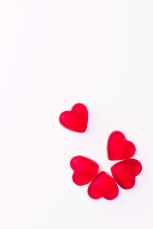 Concept of flower made of heart shaped red jelly sweets on isolated white background for Valentines Day celebration. Top view. Copy space.の写真素材