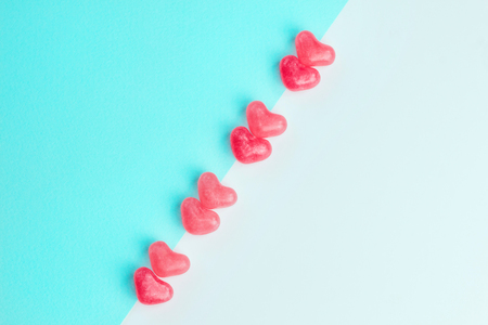 Concept made of heart shaped pink jelly sweets on blue and white background. Top view. Copy space. Valentines Day. Top view. Copy space.の写真素材