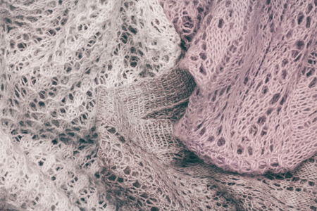 Piled stylish knitted pastel colored sweaters in different knitting patterns. Winter and spring season knitwear clothing.の写真素材