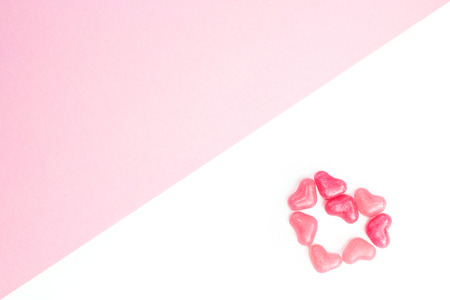 Concept of a lonely heart made of heart shaped pink jelly sweets on isolated white background. Valentines Day. Top view. Copy space.の写真素材