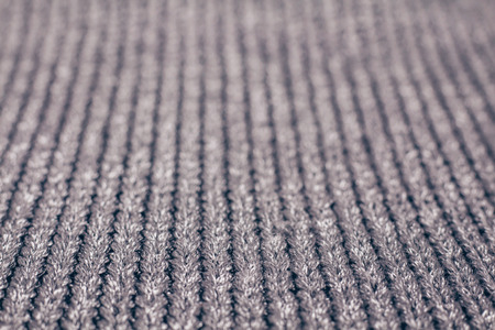 Blurred abstract background of grey knitted fabric made of silvery yarn. Close up.の写真素材