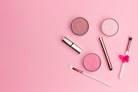 Flat lay composition with decorative makeup products on pastel pink background. Copy space.の写真素材