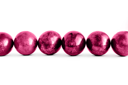 Trendy pink Easter eggs lined on isolated white background. Close-up. Copy space.の写真素材