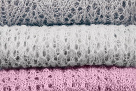 Stylish knitted pastel colored sweaters and one in sweet lilac trendy color of spring and summer 2019. Knitwear clothing with clearly visible texture. Close up, copy space.の写真素材