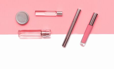 Flat lay composition with decorative makeup products and parfume on coral and isolated white background. Makeup and beaty concept. Copy space.の写真素材