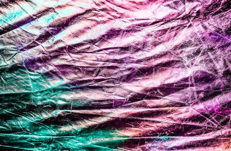Textured silver foil background with shiny crumpled surface in trendy colors.の写真素材