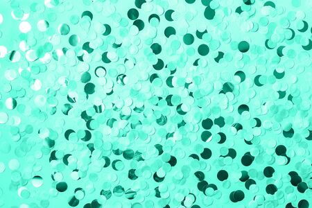 Festive background with round paper confetti in trendy mint color. Holiday concept. Copy space.の写真素材