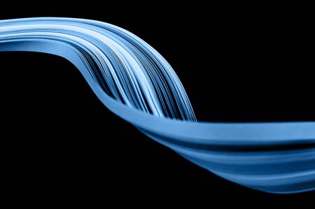 Macro photo of bright wavy paper tapes on isolated black background. Abstract modern background in...