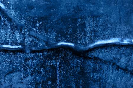 Crumpled and scratched metal texture in trendy blue color. Color of the year 2020 concept. Mockup for your design. Abstract background. Copy space.の写真素材