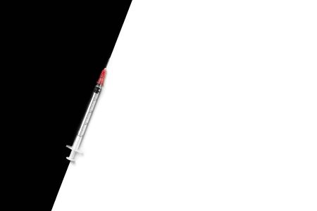 Empty syringe on black and white background. Flat lay style. Copy space. Medical treatment and women beauty concept.の写真素材