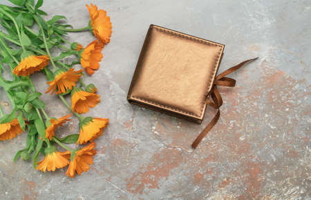 Beautiful vintage present box tied with silk ribbon decorated with marigold flower bouquet.
