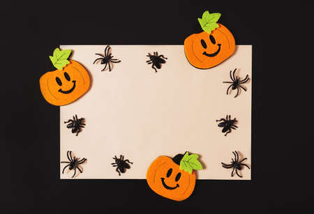 Cartoon Halloween background white vintage yellow paper blank with black spiders and pumpkins on black backdrop. Copy space. Flat lay style. Halloween abstract background. Dark retro black and white background.の写真素材