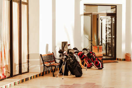 Set of golf clubs and equipment awaiting in front hotel or golf club for lifestyle design. Sport leisure lifestyle concept. Summer vacation.の写真素材