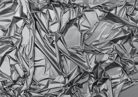 Shiny crumpled surface of trendy gray foil for textured background. Backdrop for your design. Color 2021 concept. Copy space.の写真素材