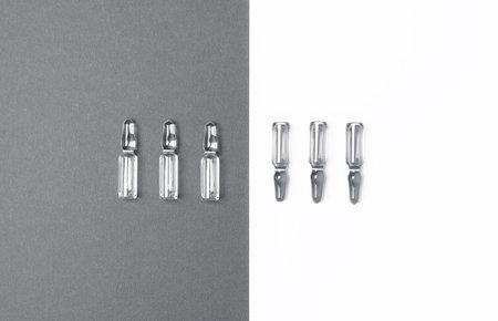 Line of ampules for injections on trendy gray and isolated white background. Medicine, healthcare...