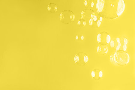 Abstract beautiful trendy yellow background with soap bubbles. Color 2021 concept. Backdrop for your design. Place for text.の写真素材