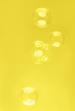 Abstract beautiful trendy yellow background with soap bubbles. Color 2021 concept. Backdrop for your...