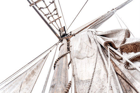Wooden old ship in vintage style with all sails set in misty lake. Moody background.
