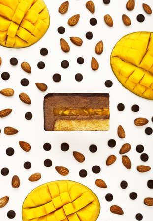 Top view of delicious chocolate mango mousse cake slice with the layers displayed and recipe...