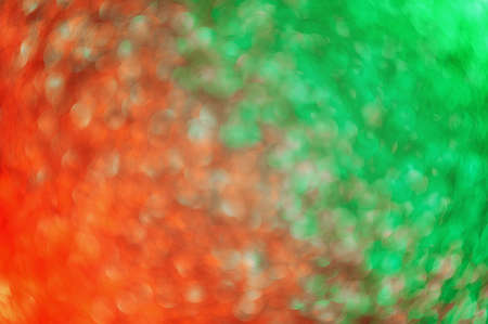 Abstract Christmas traditional green and red gradient glitter background. Great backdrop for any holiday or event. Bokeh light overlay. Color gradient glow.の写真素材