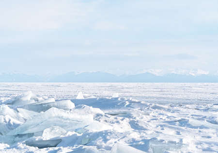 Winter landscape with mountains and Lake Baikal in Siberia at sunset. Natural background.