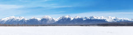 Winter landscape panorama with Sayan Mountains in Siberia on sunny winter day. Natural background.の写真素材