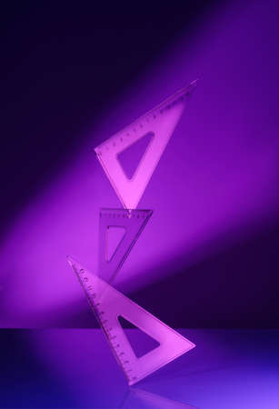 Creative minimal composition made with school supplies flying in the air in neon colors with copy space. Back to school. Suitable for advertising, marketing, ads. Minimal, conceptual art. Cyberpunk and cosmos aesthetics.の写真素材