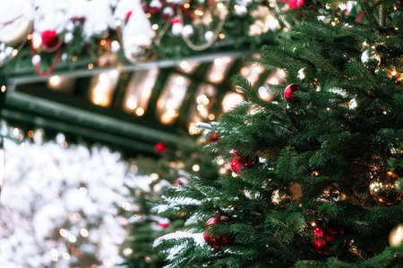 Beautiful fir tree decorations and lights of traditional Christmas fair. Holidays concept. Winter...