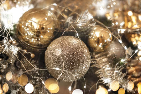 Beautifully decorated and illuminated Christmas tree with golden decoration and bokeh. Vintage toning.の写真素材