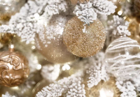 Beautifully decorated and illuminated Christmas tree with golden decoration and bokeh. Vintage toning.の写真素材