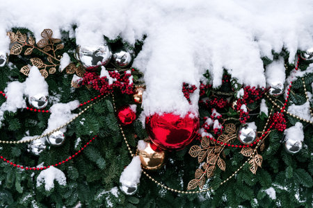 Beautiful snowy fir trees decorations and lights of traditional Christmas fair. Holidays concept. Winter holiday season background.の写真素材