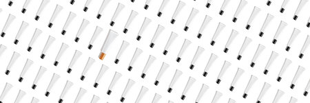 Creative seamless pattern of black and white cosmetic tubes on white background. Cosmetics, skin care, beauty, body treatment concept. Creative design in flat lay style. Top view. Mock-up.の写真素材